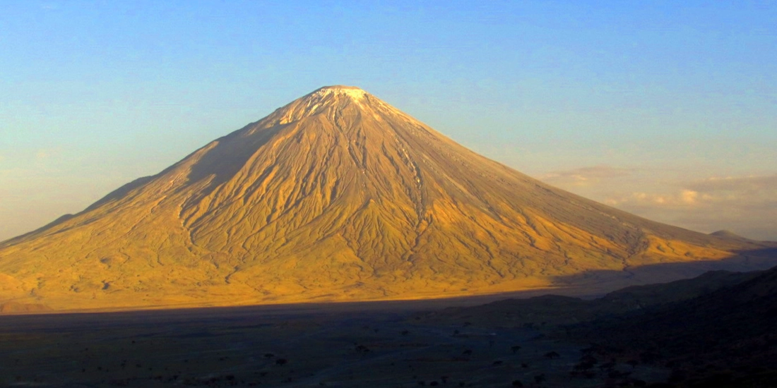 Ol Doinyo Lengai's pyramid-shaped peak seen from Lake Natron