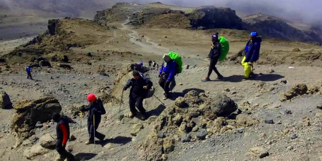 Trekkers walking pole pole (slowly, slowly), the Kilimanjaro mantra